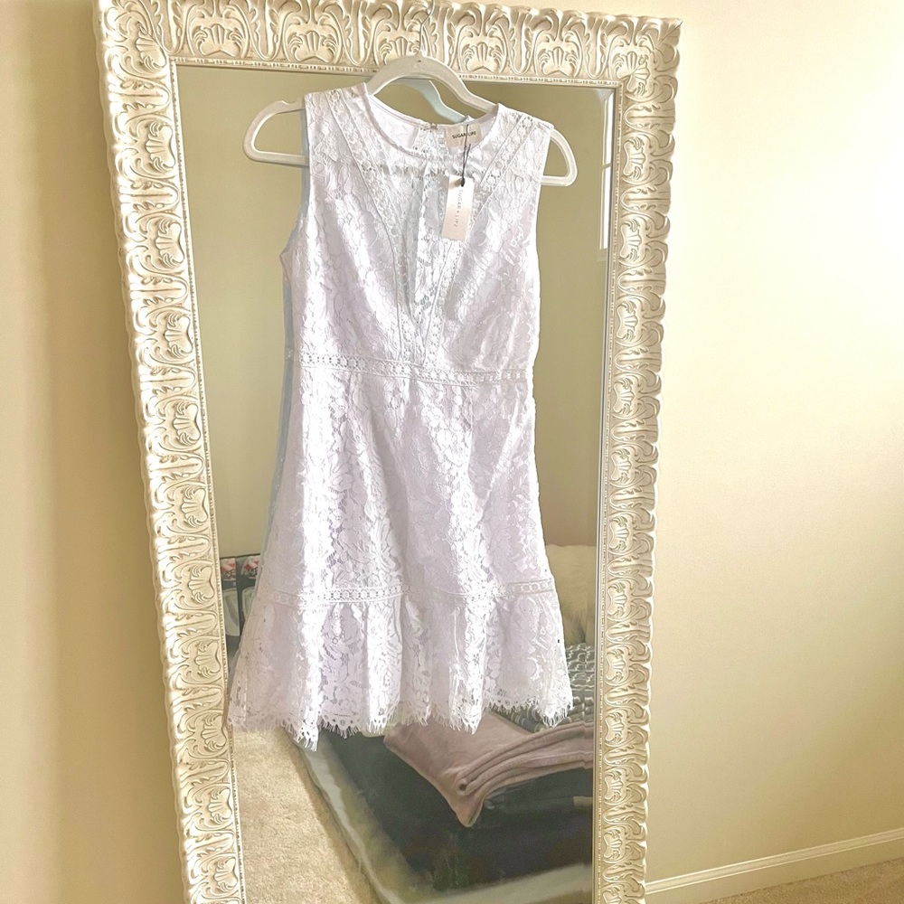 Sleeveless white lace dress. Bought but never worn.